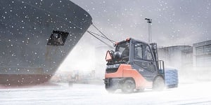 forklift truck operating in winter conditions in a shipyard
