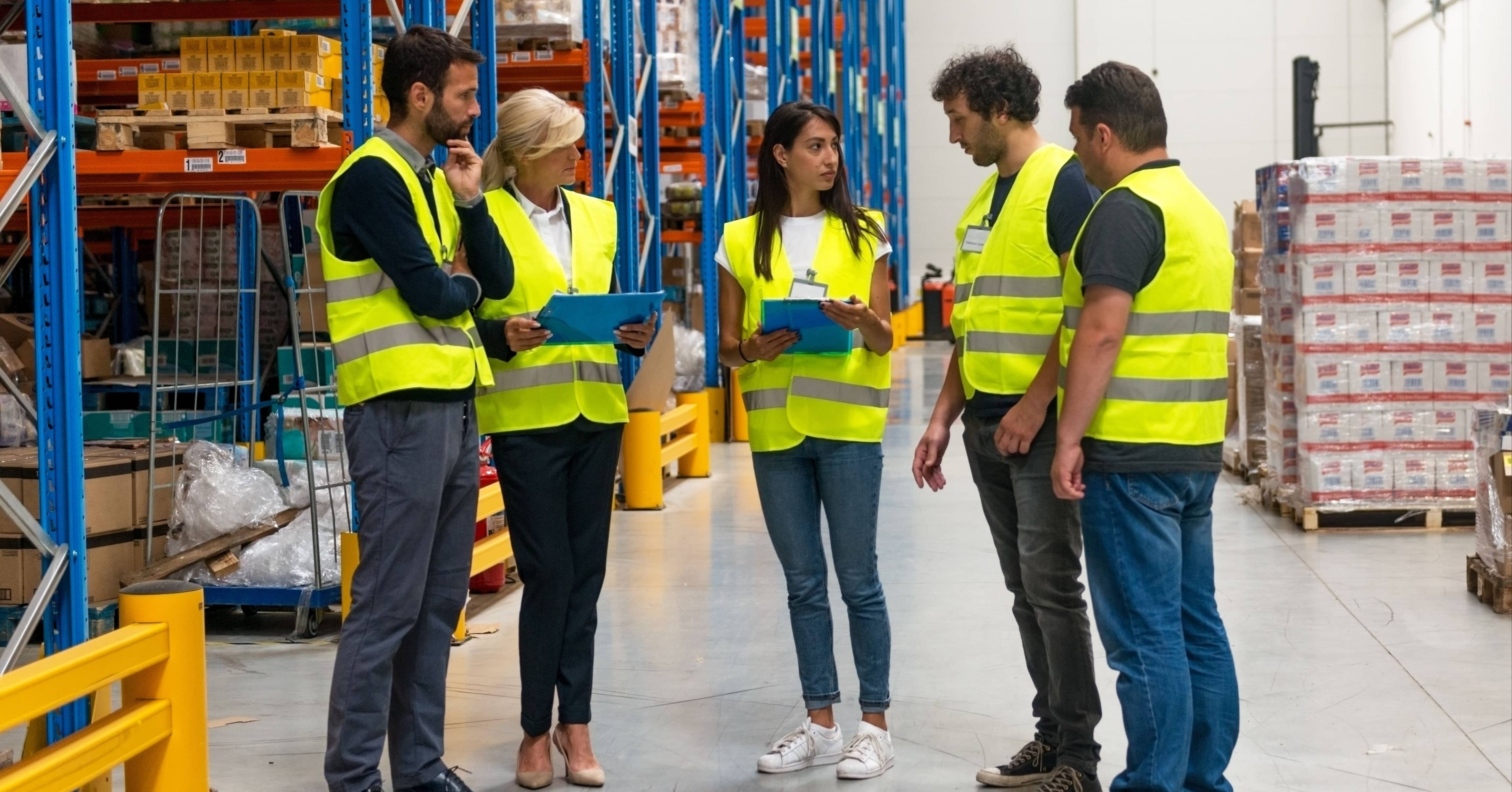 warehouse workers discussing health and safety